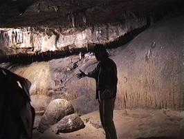 Our Tour Guide describes the impressive Flowstones in Ingleborough Cave
